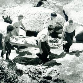 Victim being carried on a stretcher by rescue workers