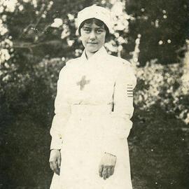 Female nurse standing in a garden