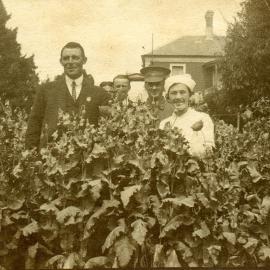 Men and women in a garden "Hathrop 1917"