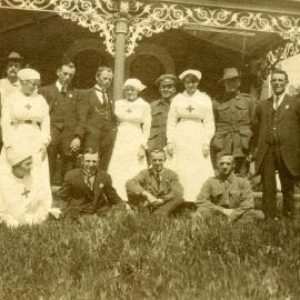 Group of men, nurses and soliders standing in front of a Pavilion at "Hathrop", 1917