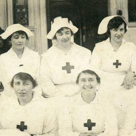 Postcard of Nurses sitting on Steps in front of a hospital