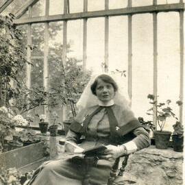 Nurse sitting in a greenhouse