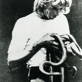 Professor Fred Fox holding a few snakes