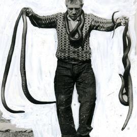 George Cann holding snakes