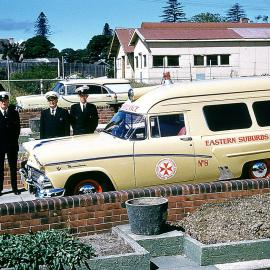 Ambulance Officers and cars in the Station's driveway