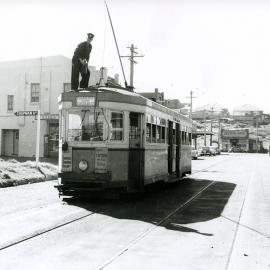 Driver on Tram roof conducting maintenance