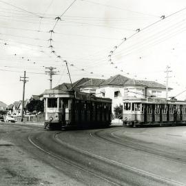 Trams passing at the turn into Mons Avenue