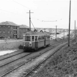 Tram on Anzac Parade near Coral Sea Park Housing Estate
