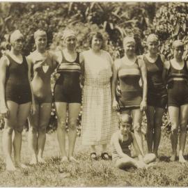 Seven female swimmers and a chaperone